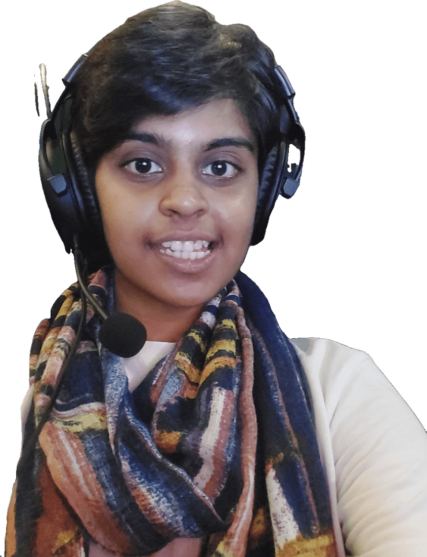 Riya grinning on the mic in a headset and patterned scarf